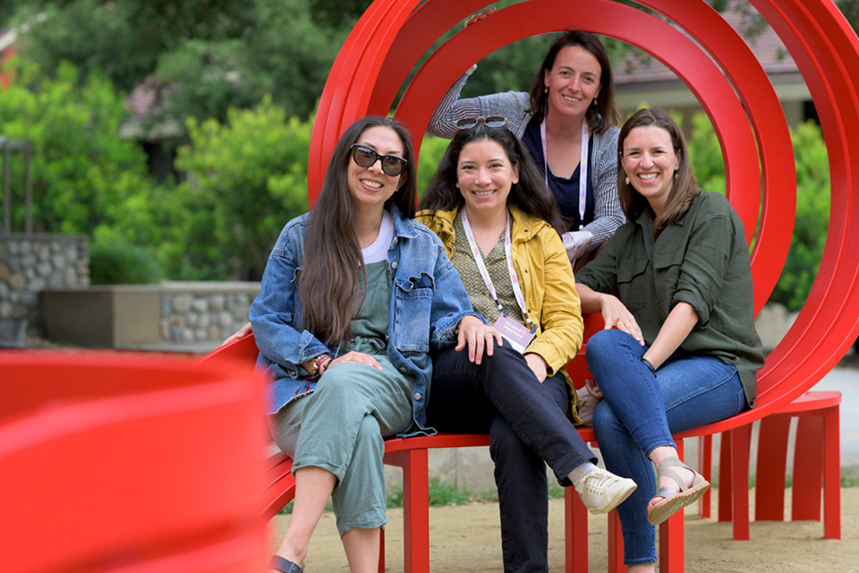 A group of women seated on one of Jeppe Hein's "Social Benches."