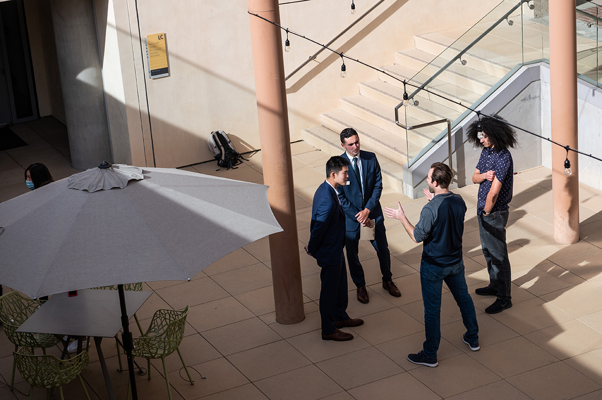 Miles Bird '13 in a discussion with students at one of the basement patios in front of Kravis.