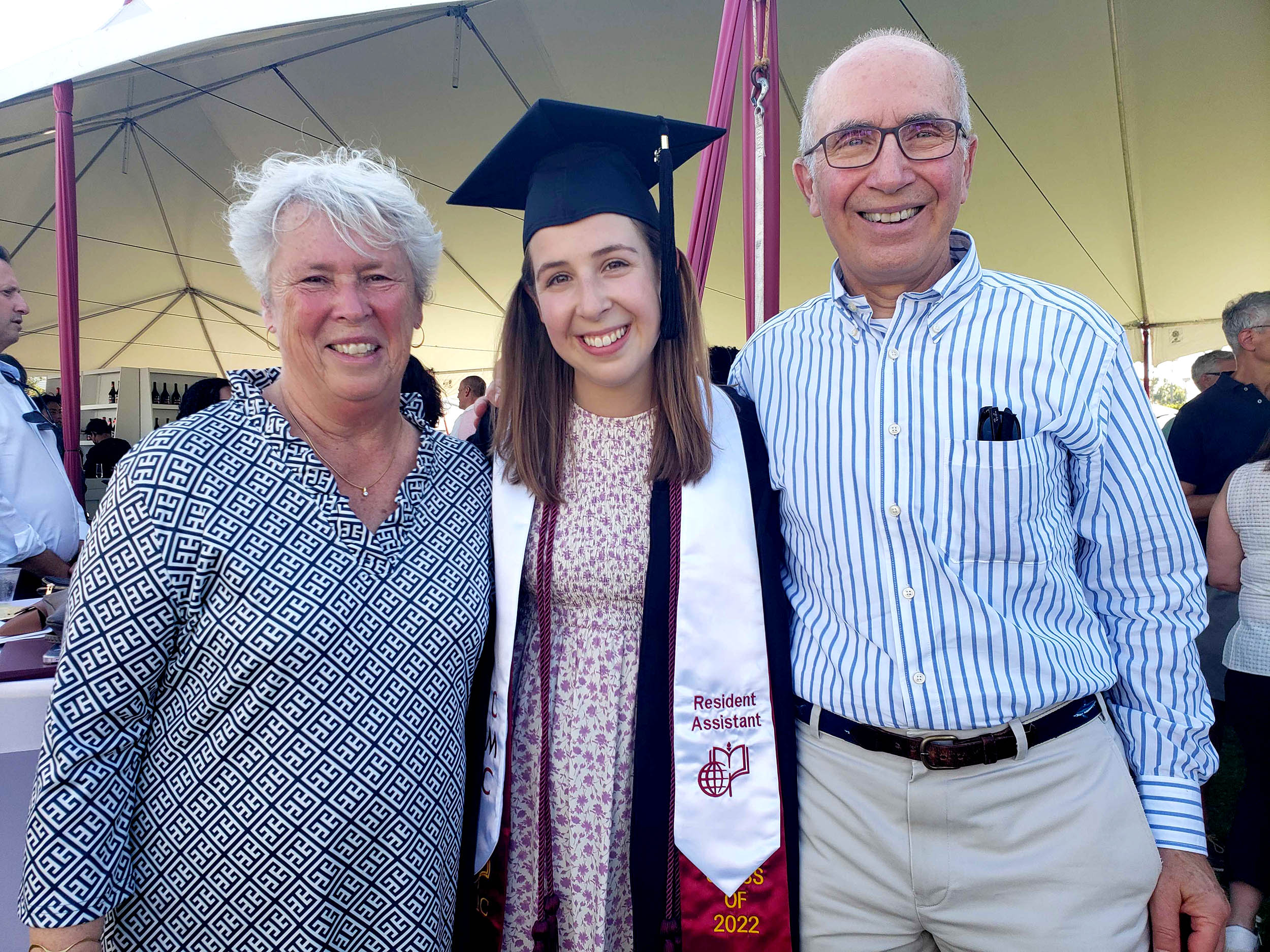 Anna Green ’21 stands with her parents at CMC's 2022 Commencement.