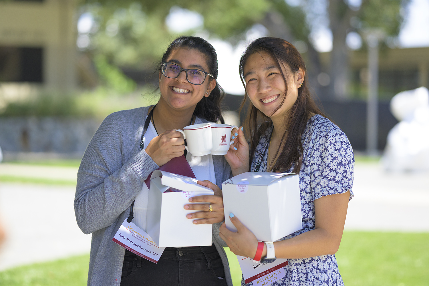 Sam Lee ’20 and Tara Renduchintala ’20 pictured together holding up their gifted Athenaeum tea cups featuring the historic griffon logo.