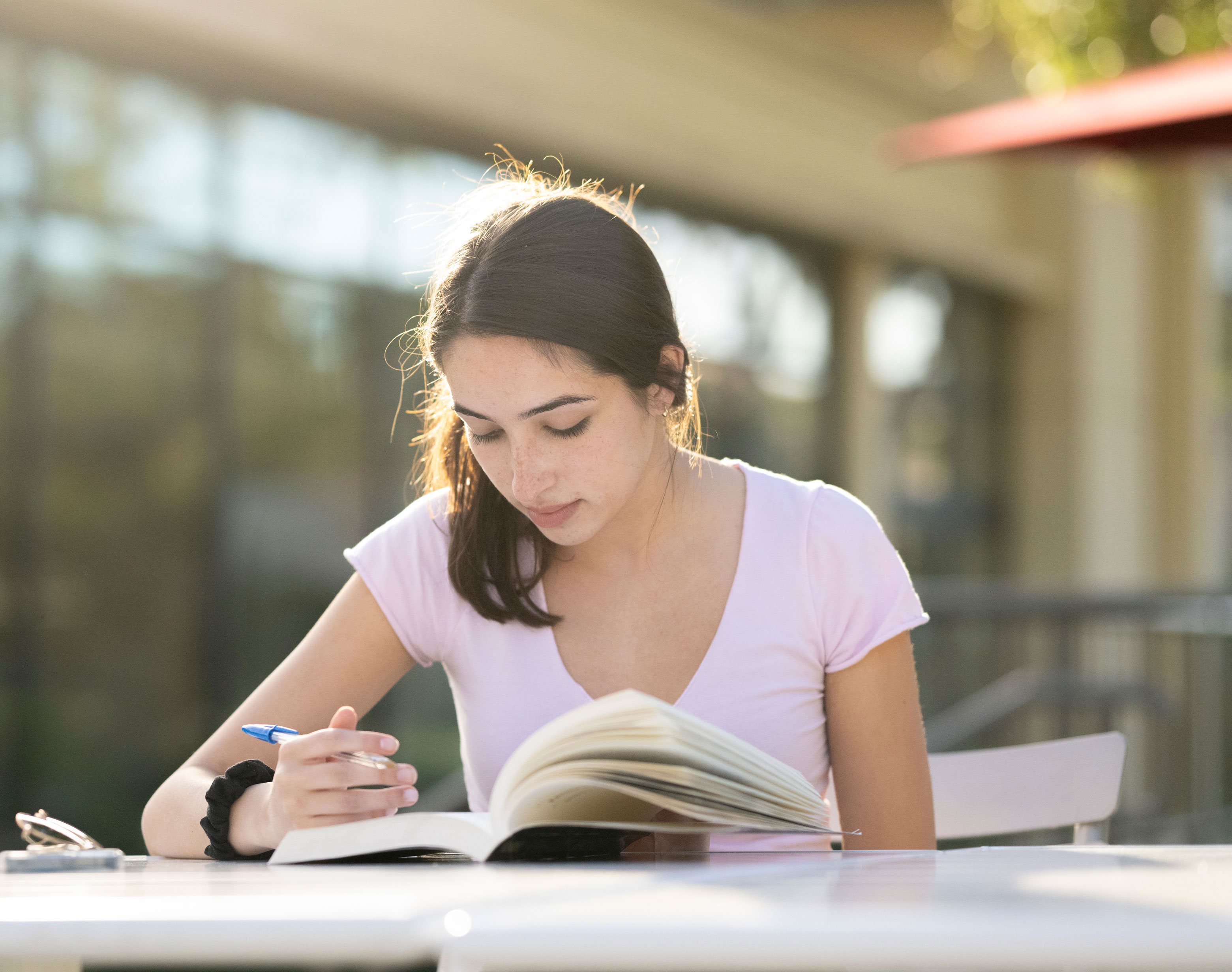 Student studying outside on campus.