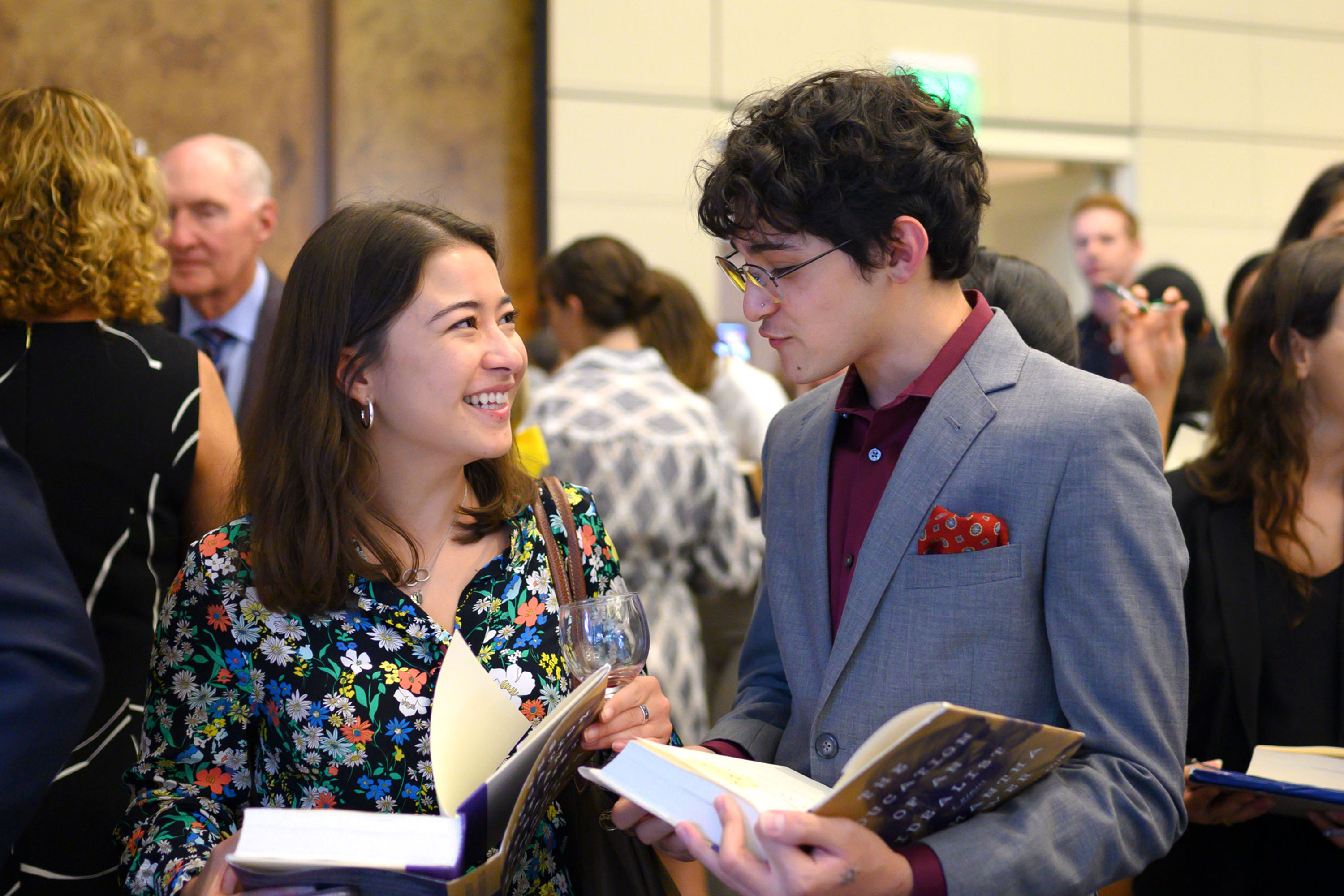 Two students speaking together at book event.