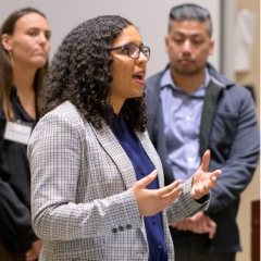 Candace Valenzuela '06 engaged in discussion at the CMC Ath.