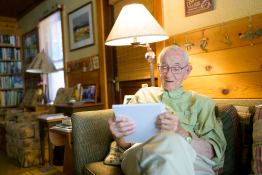 Jack Stark looking at family photos inside Starks' cabin.