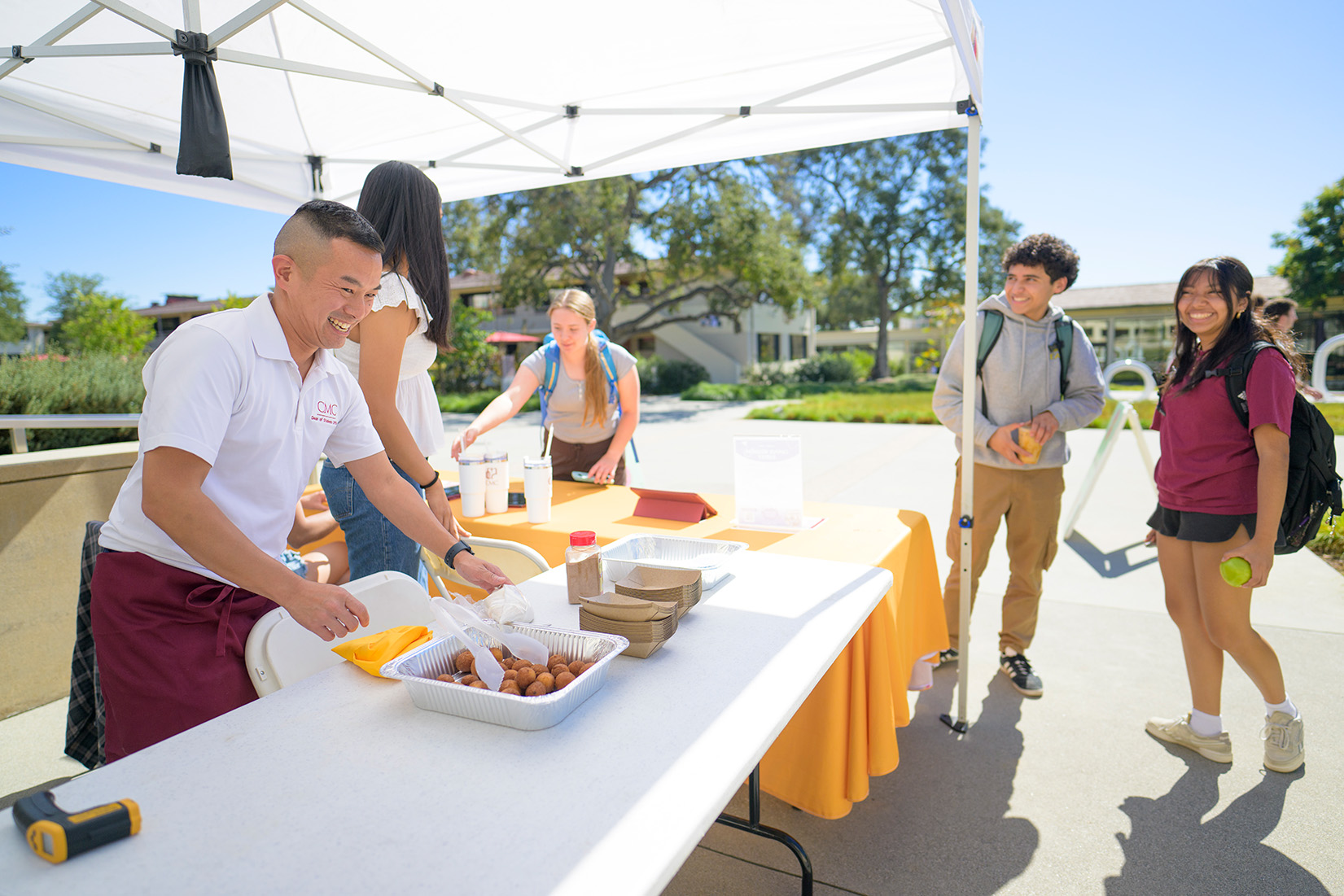 Jimmy Doan serving donuts to students.