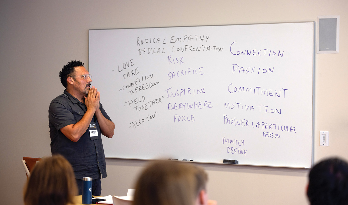 Nicolas Buccola in front of whiteboard in class.