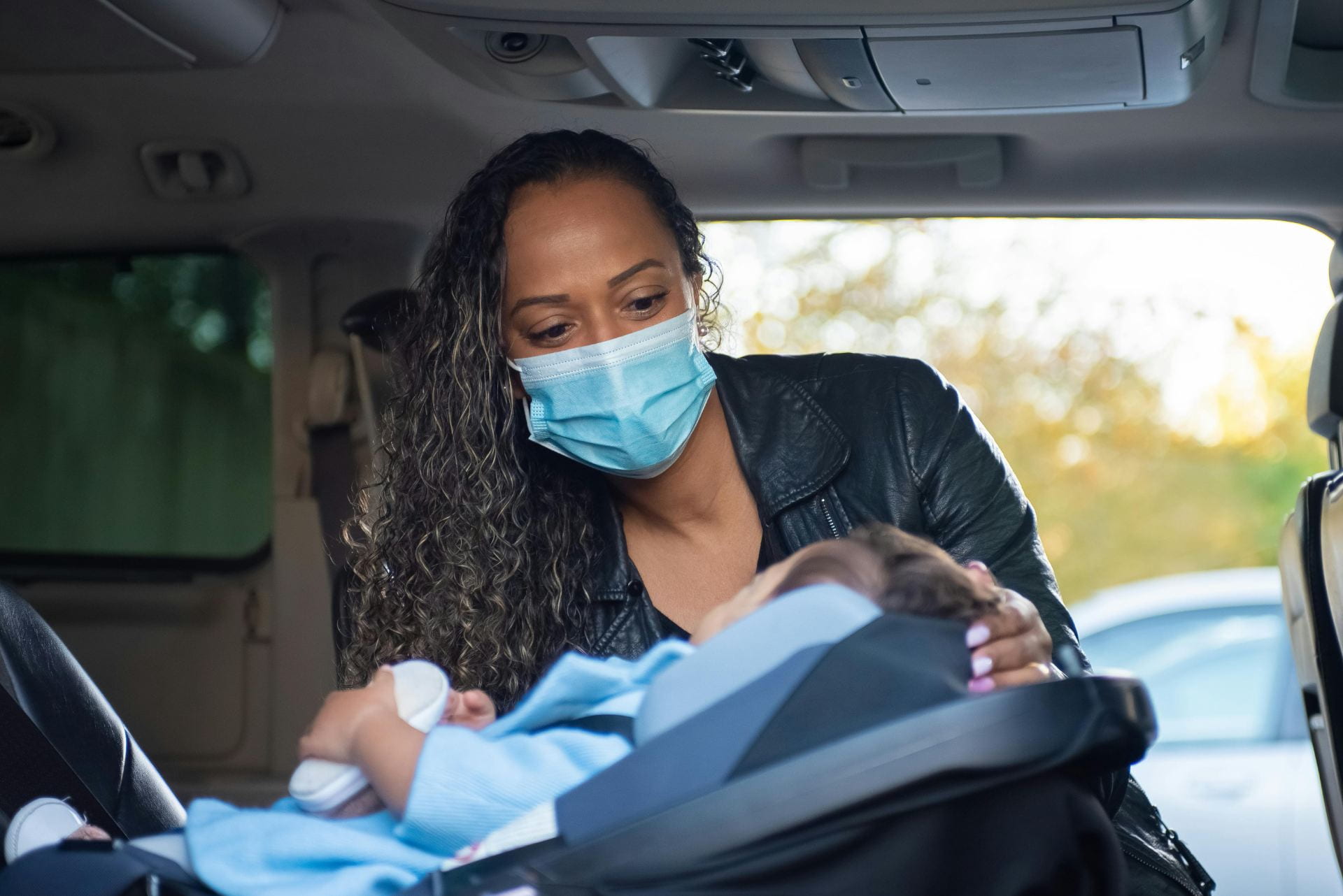 A caregiver with a mask treating a patient. 