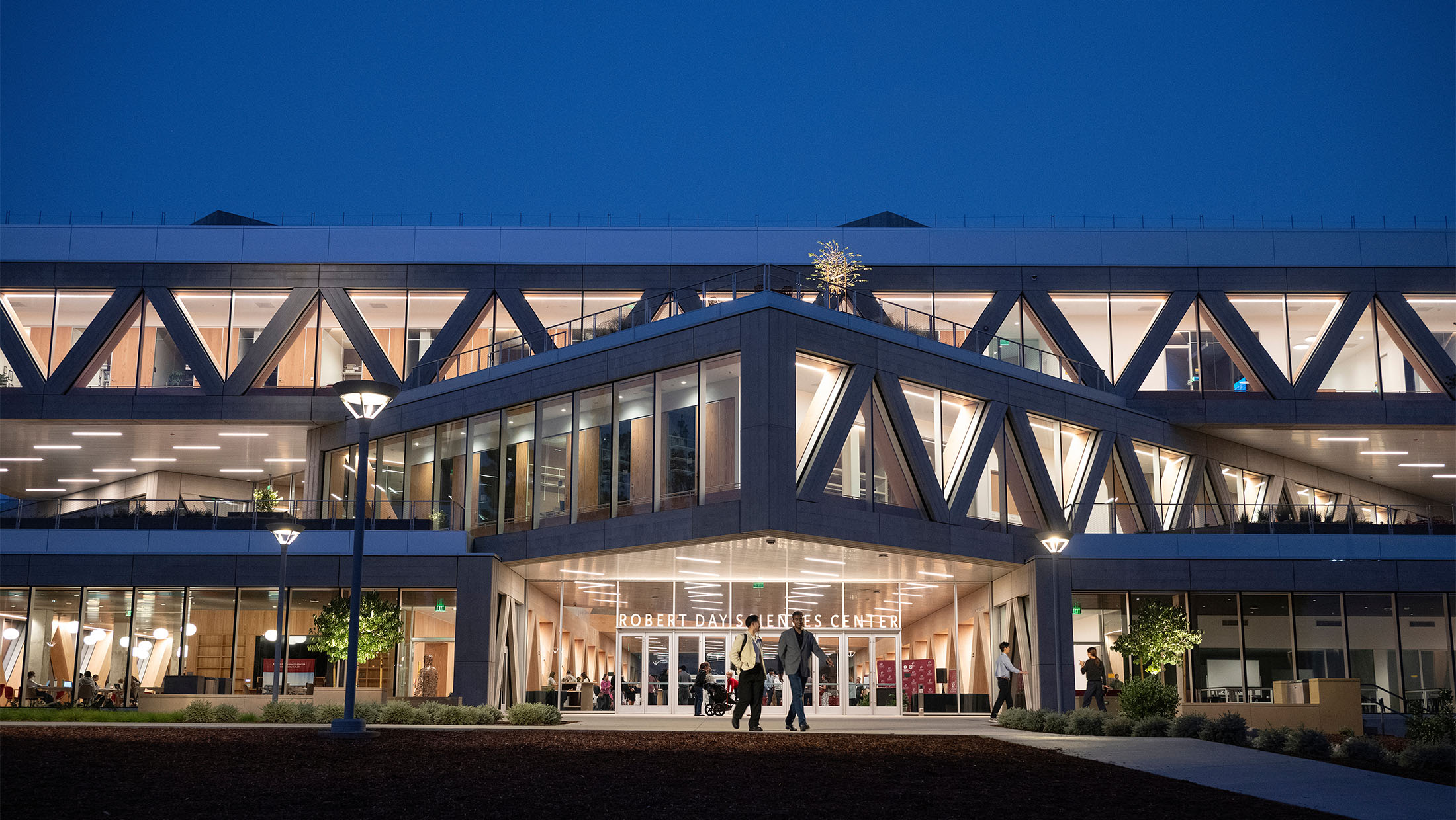 The Robert Day Sciences Center illuminated at night.