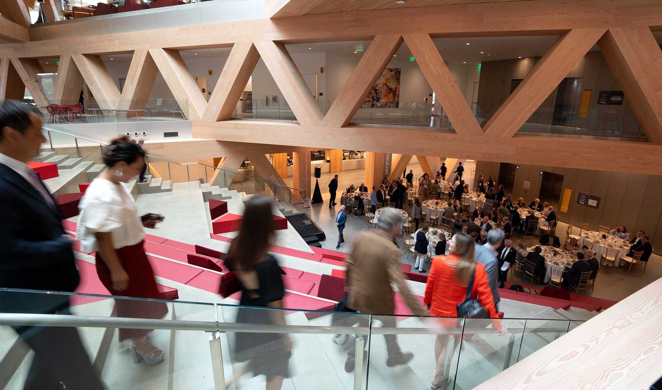 People walking down stairs to trustee lunch at RDSC opening