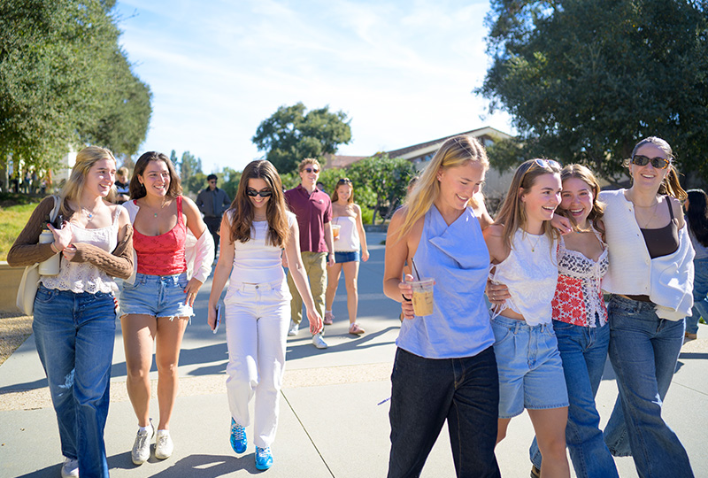 A group of students walking campus during the first day of Spring 2025.