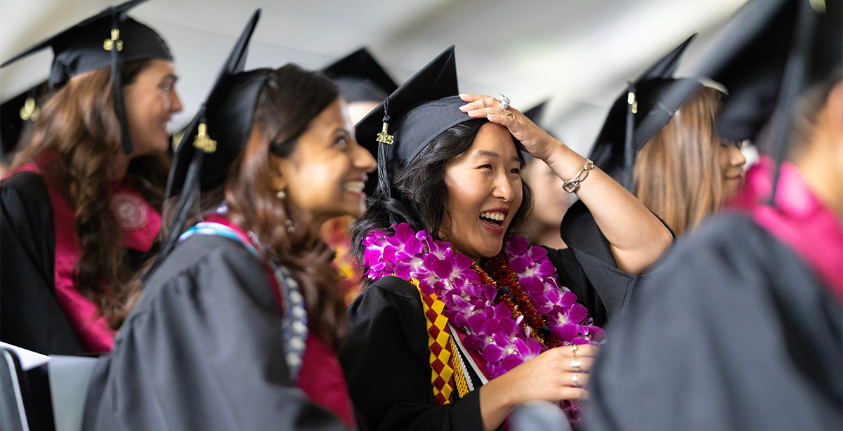 Graduates look on during Commencement.