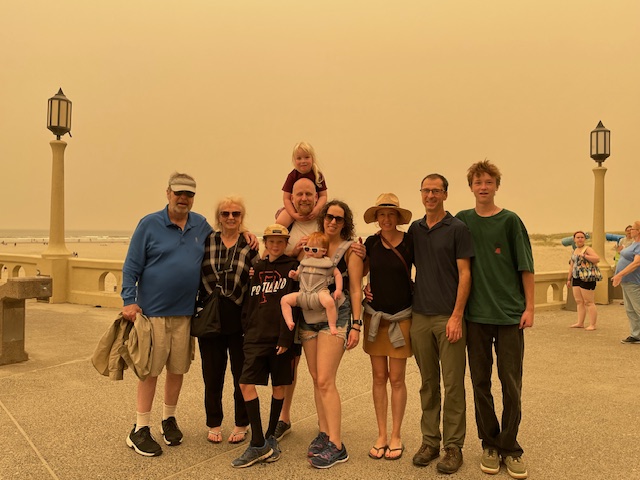 Mixed group of men and women standing in outdoors summer clothing.