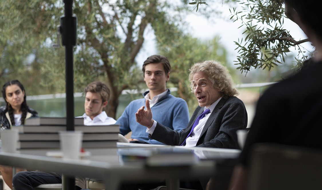 Steven Pinker sits surrounded by students at a discussion event hosted by Professor George Thomas of the Salvatori Center.