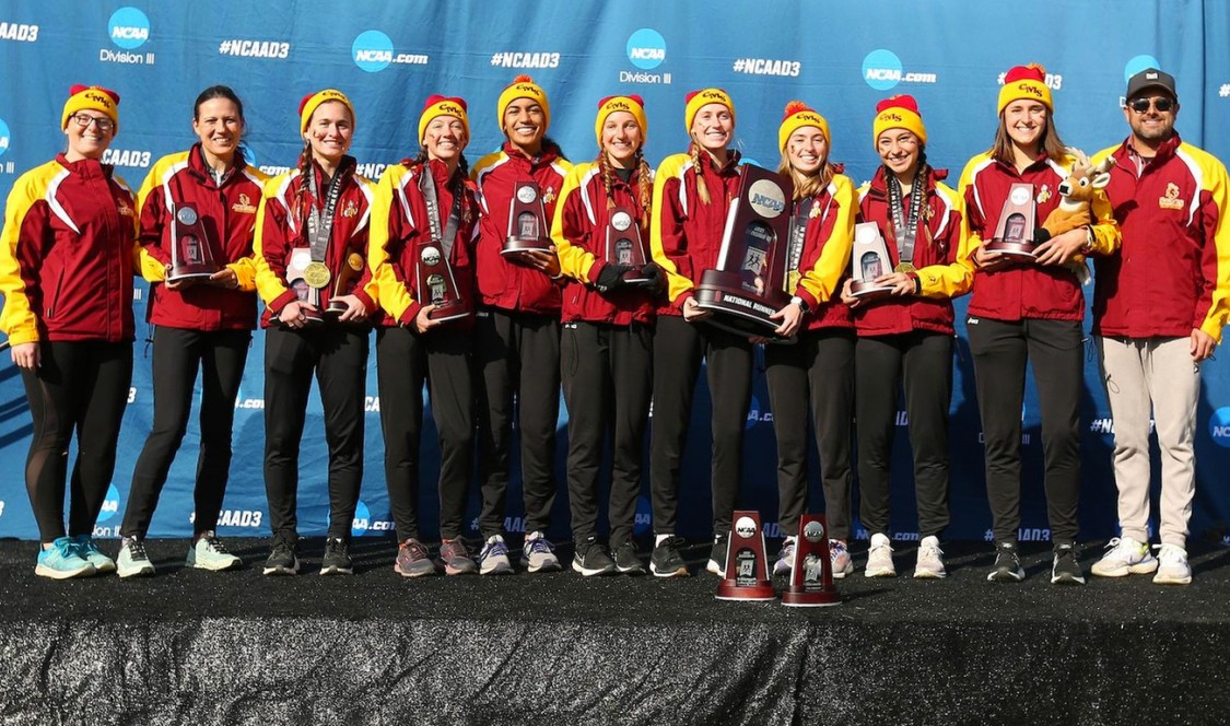 CMS Athenas Cross Country pose on the winner's podium with their NCAA runner-up trophy.