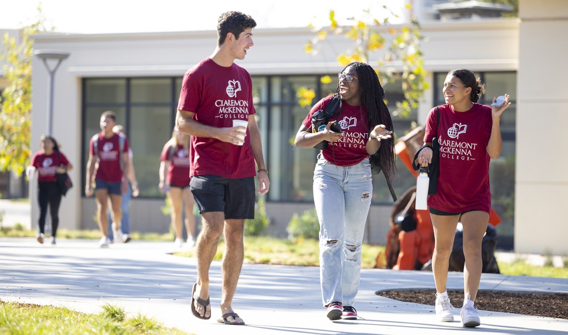 Students who arrived early to campus walk by Collins in their CMC maroon t-shirts.