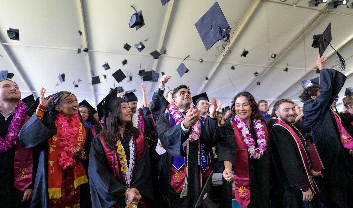 Students tossing their caps during Commencement 2024.