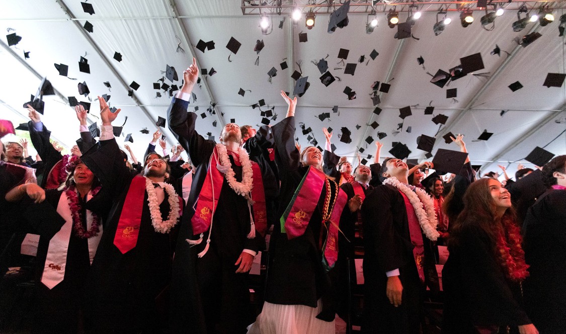 Students throwing caps in air at Commencement 2025