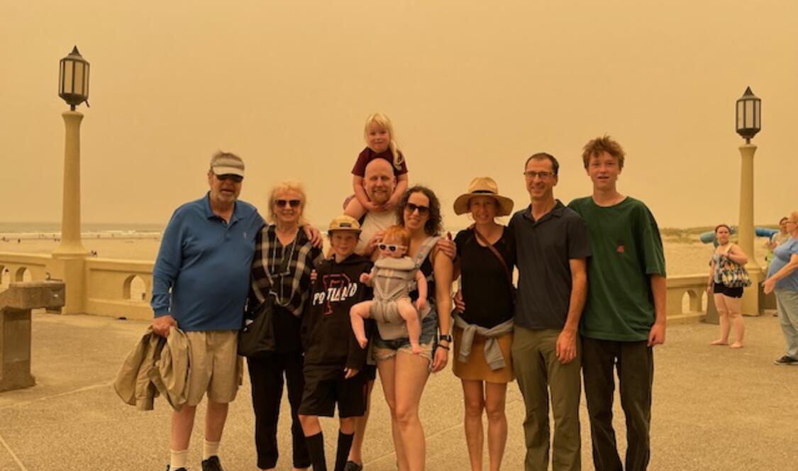 Mixed group of men and women standing in outdoors summer clothing.