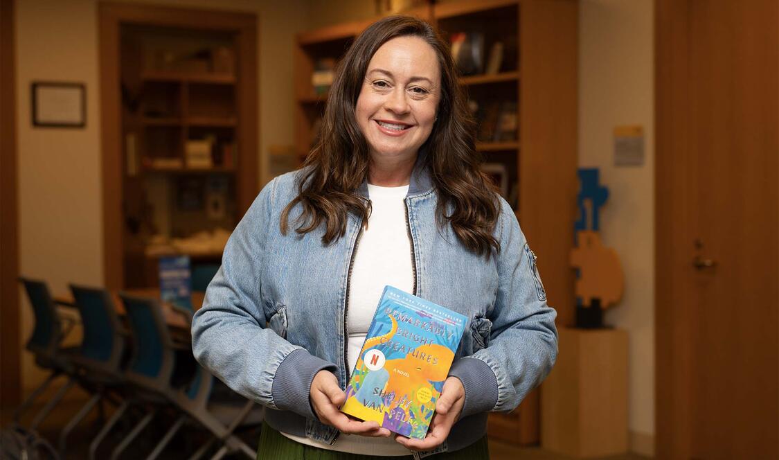 Shelby Van Pelt '02 holding her book, "Remarkably Bright Creatures"