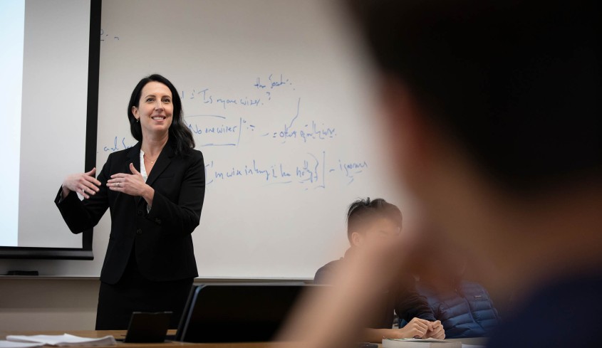 Prof. Shanna Rose in front of classroom