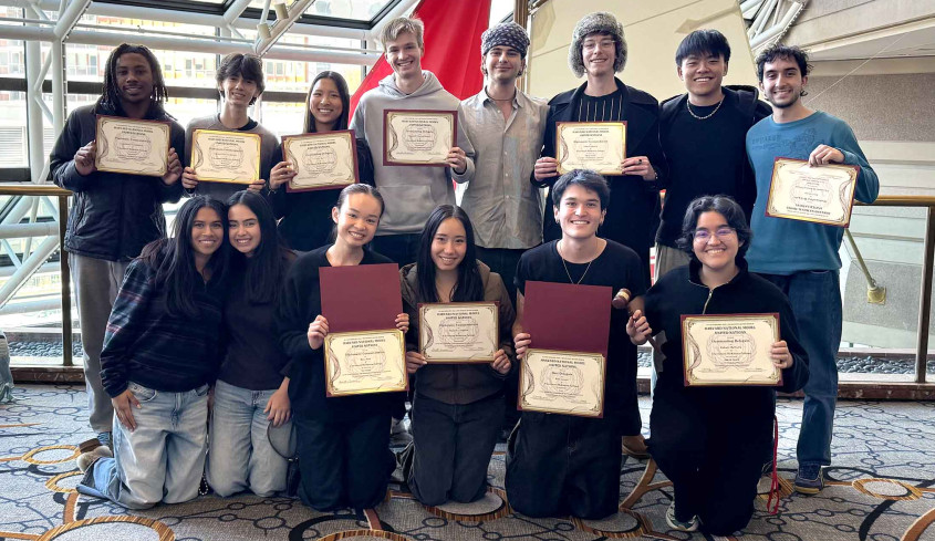 MUN students posing with their awards