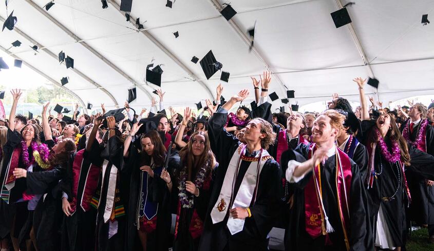 The Class of 2026 tossing their caps after the ceremony.