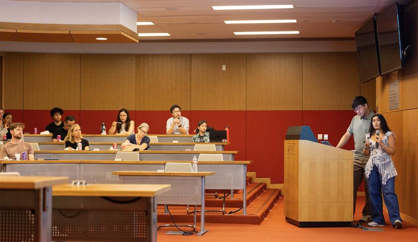 Student at podium presenting work from Summer Research Program