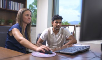 Professor Vossmeyer (left) navigates her office computer while Somu Amujala ’23 (right) observes.