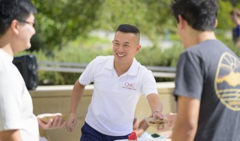 Jimmy Doan talking with students on campus