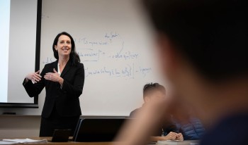 Prof. Shanna Rose in front of classroom