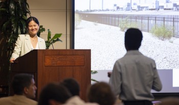 Karen Hao speaking at podium at the Ath