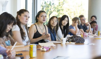 Group of students listening at table