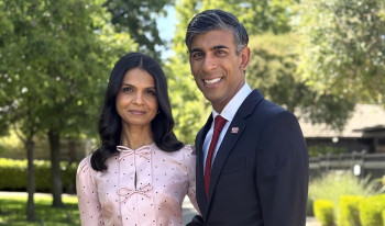 Rishi Sunak and Akshata Murty standing in garden
