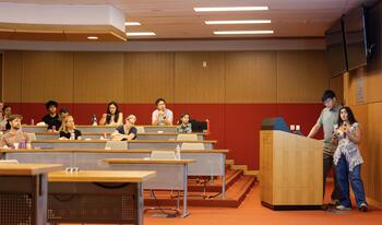 Student at podium presenting work from Summer Research Program