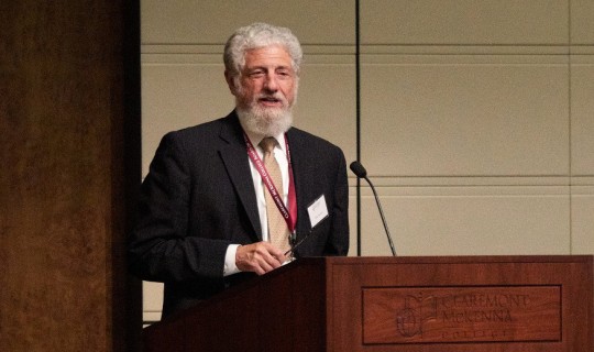 John M. Isaacson speaking at the Athenaeum podium.