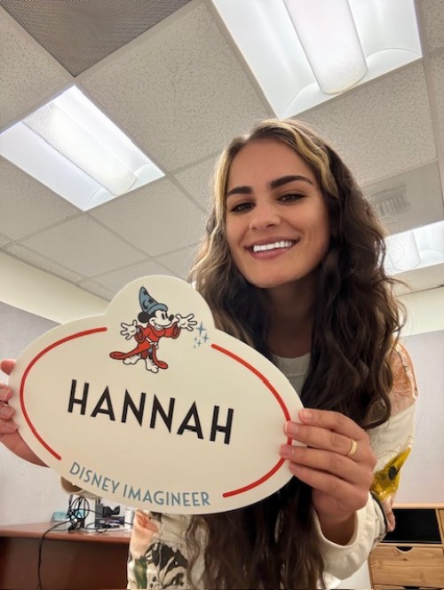 Hannah Alderete '20 holds up her office name plaque at the Disney Imagineer office.