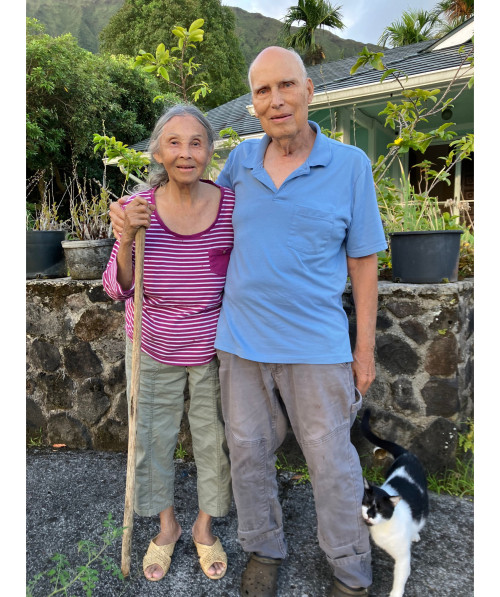 Philip Chrones '66 outside his home with his wife and cat.