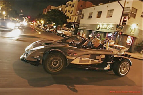 Man driving inside sports car on the street. 