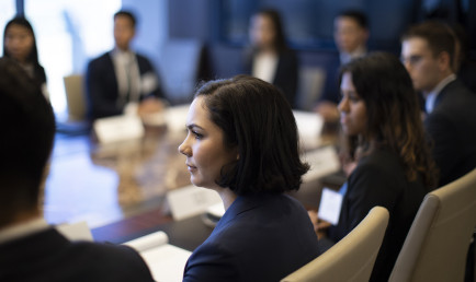 CMC students seated at a table wearing black suits to a Networking Trek with Henry R. Kravis ’67 in New York, one of many opportunities available through the campus career center.