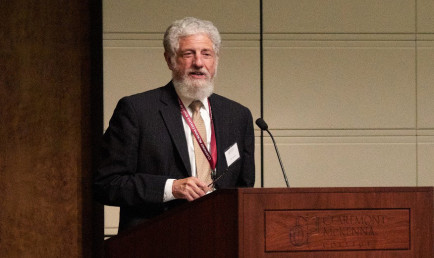 John M. Isaacson speaking at the Athenaeum podium.