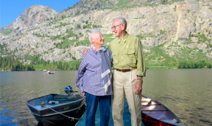 Jack (right) and Jil Stark standing on their cabin's boating dock in front of lake.