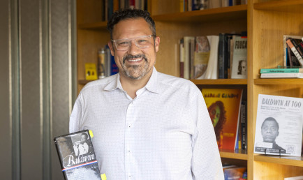 Prof. Buccola in front of a bookcase