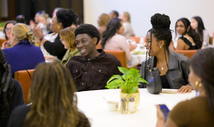 Students laughing in the Ath at the CARE Center anniversary celebration