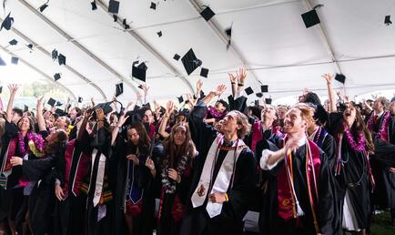 The Class of 2026 tossing their caps after the ceremony.