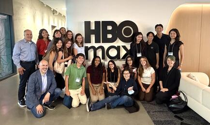 Group of students at networking trek in front of HBO sign