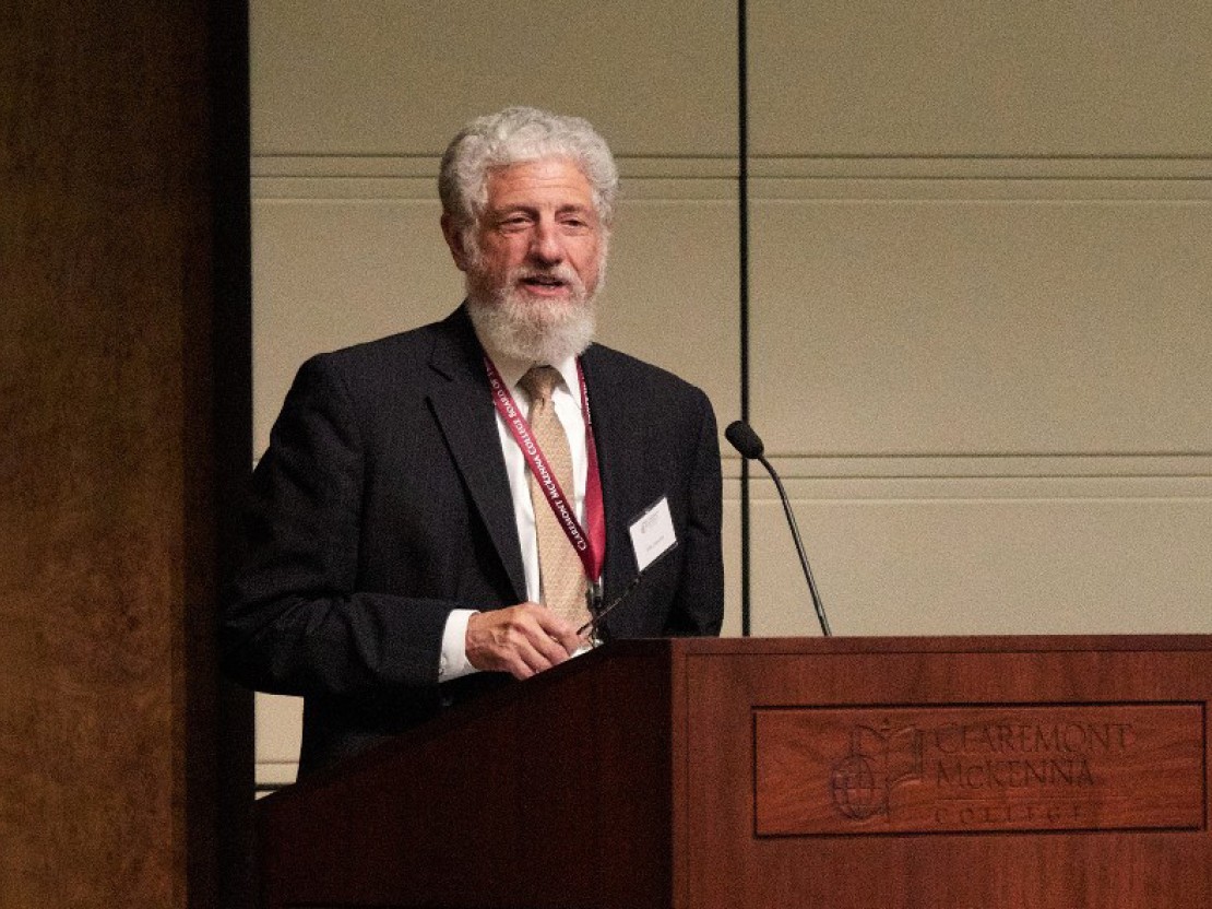 John M. Isaacson speaking at the Athenaeum podium.
