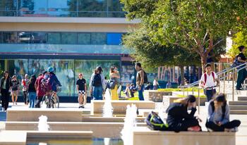 Students on campus with fountain and Kravis Center