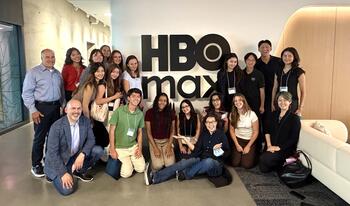 Group of students at networking trek in front of HBO sign