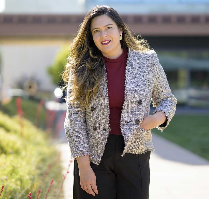 Professor Jennifer Feitosa photographed in Gann Quad on a sunny day.