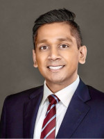 Abhi Nemani in blue suit and red tie